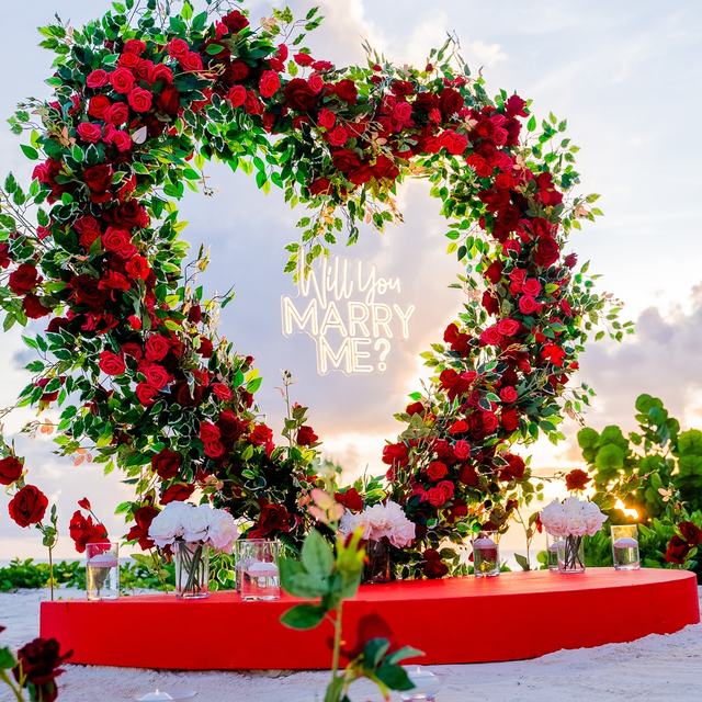 Red rose heart arch on the beach