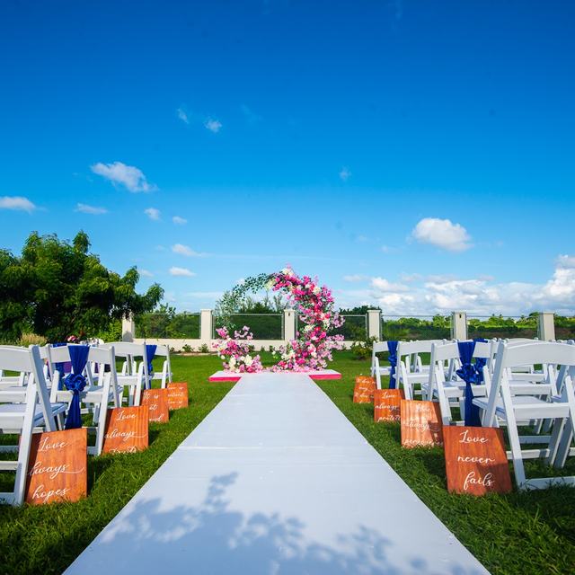 Ceremony aisle with white chairs