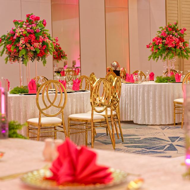 Gold chairs and rose centrepieces