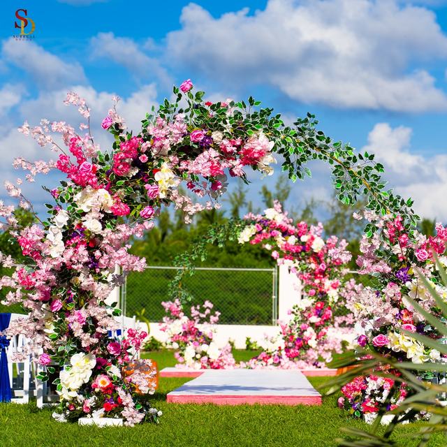 Pink floral arch at a garden ceremony